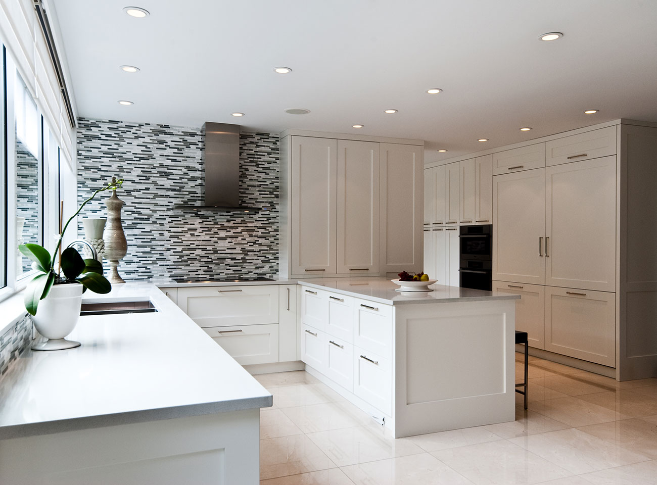 White shaker-style custom cabinetry with stone benchtops by a Queanbeyan cabinet maker